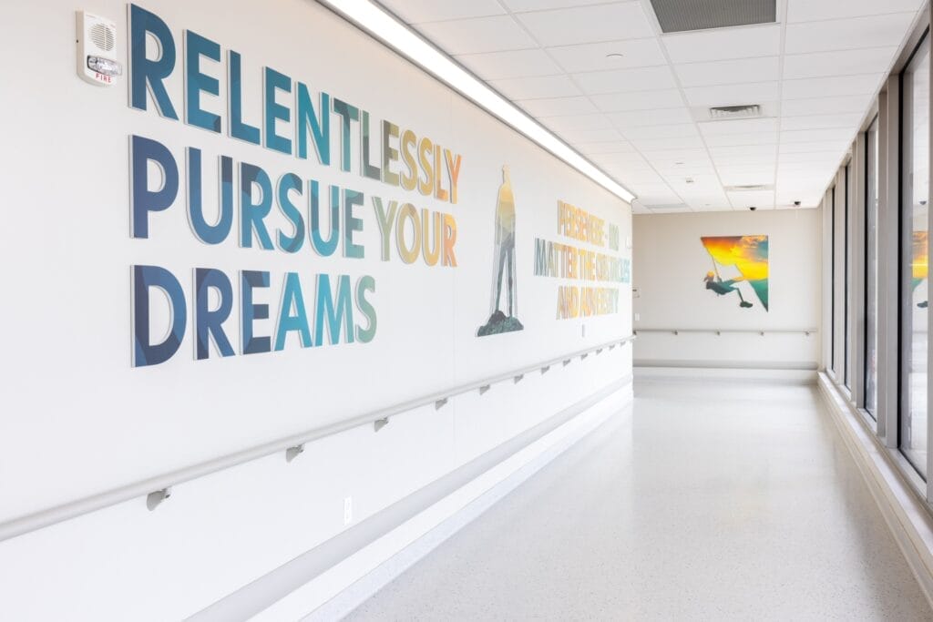 Artwork, including a message to Relentlessly Pursue Your Dreams, on a hallway in Good Shepherd Rehabilitation Hospital's private patient entrance