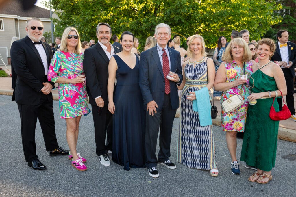 Eight Gala attendees standing and posing for a photo