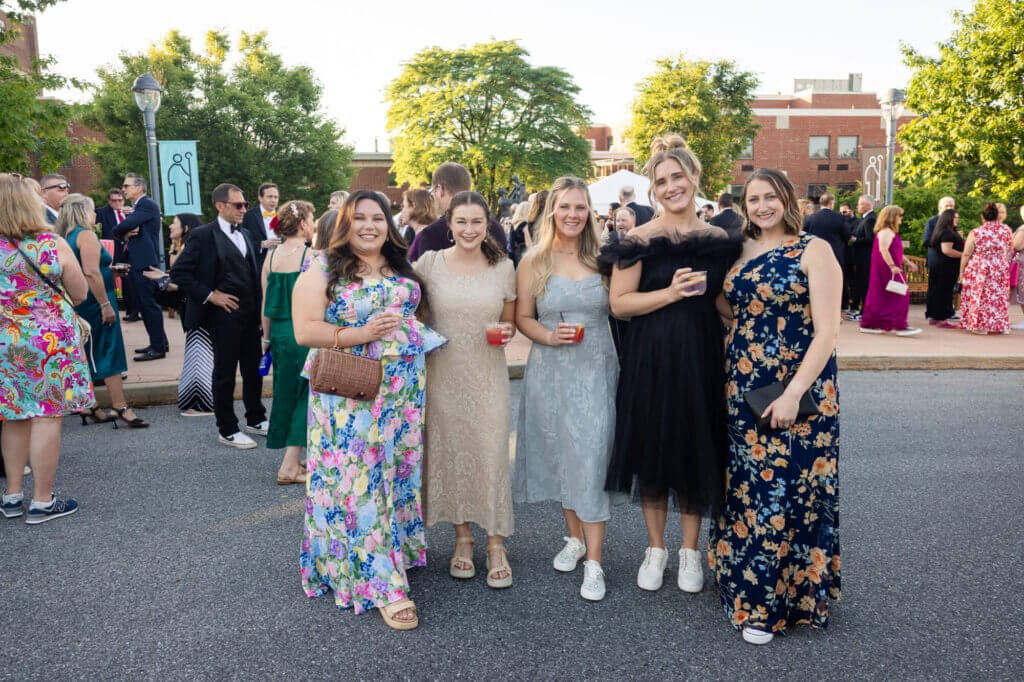 Five Gala attendees standing and posing for a photo