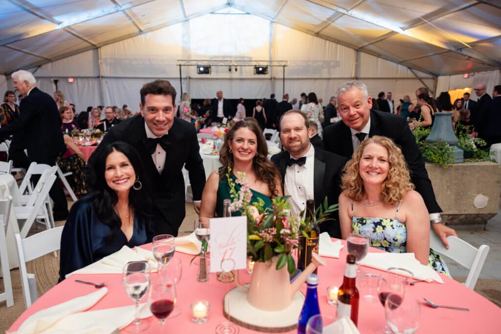 Gala attendees at a table inside the tent