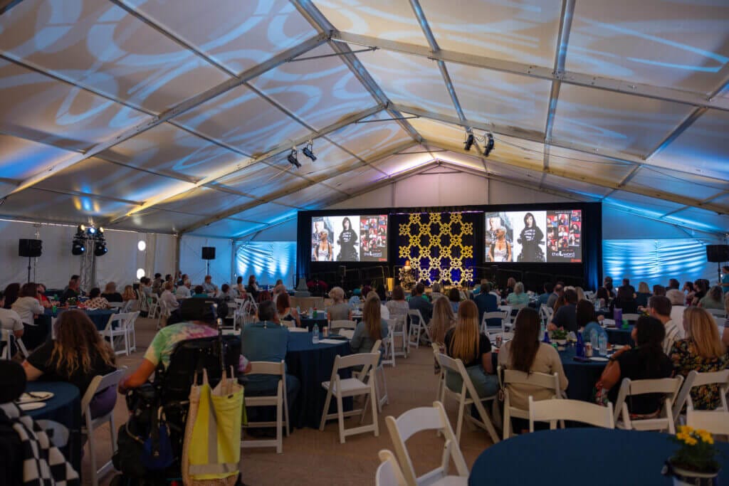 A crowd under a tent at a large event