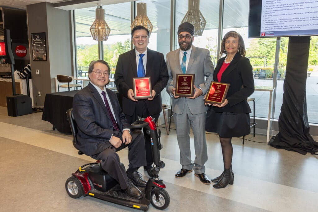 Dr. Sam Wu, Dr. Bryan O'Young, Dr. Sandeep Singh and Dr. Andrea Brown pose for a photo and smile at the camera