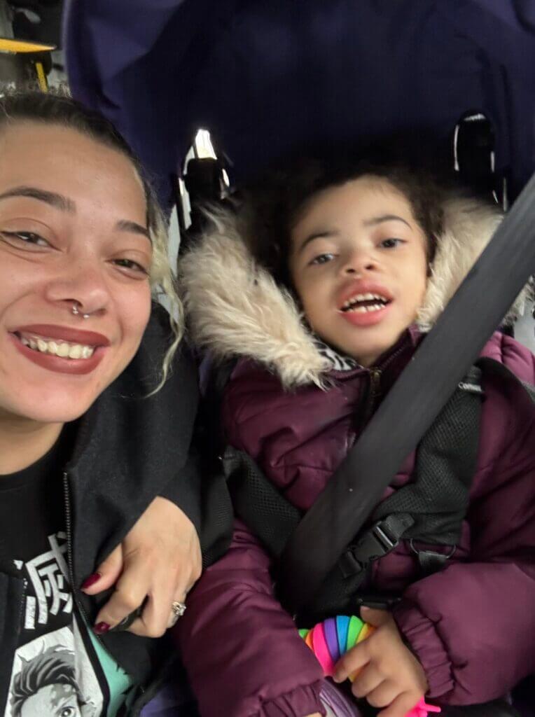 Mother and daughter in a vehicle smiling for a selfie