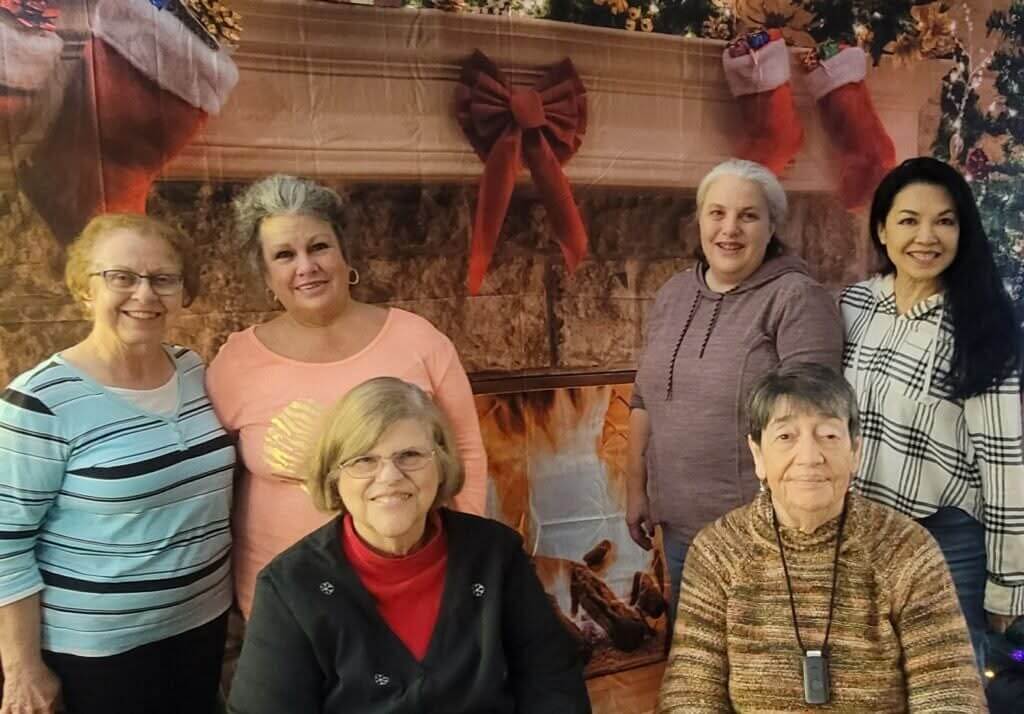 Linda Devore with her friends all standing or sitting smiling