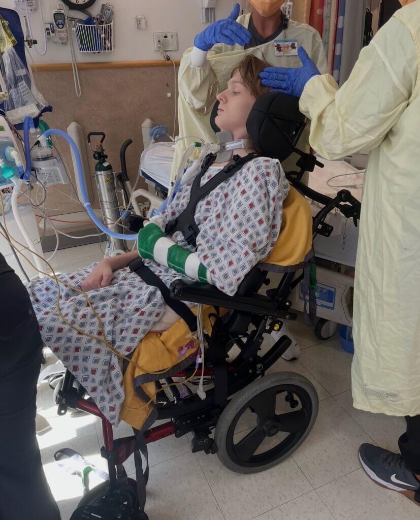 anthony in a wheelchair with doctors around him